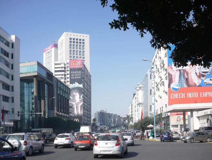 traffic traveling down a street next to tall buildings