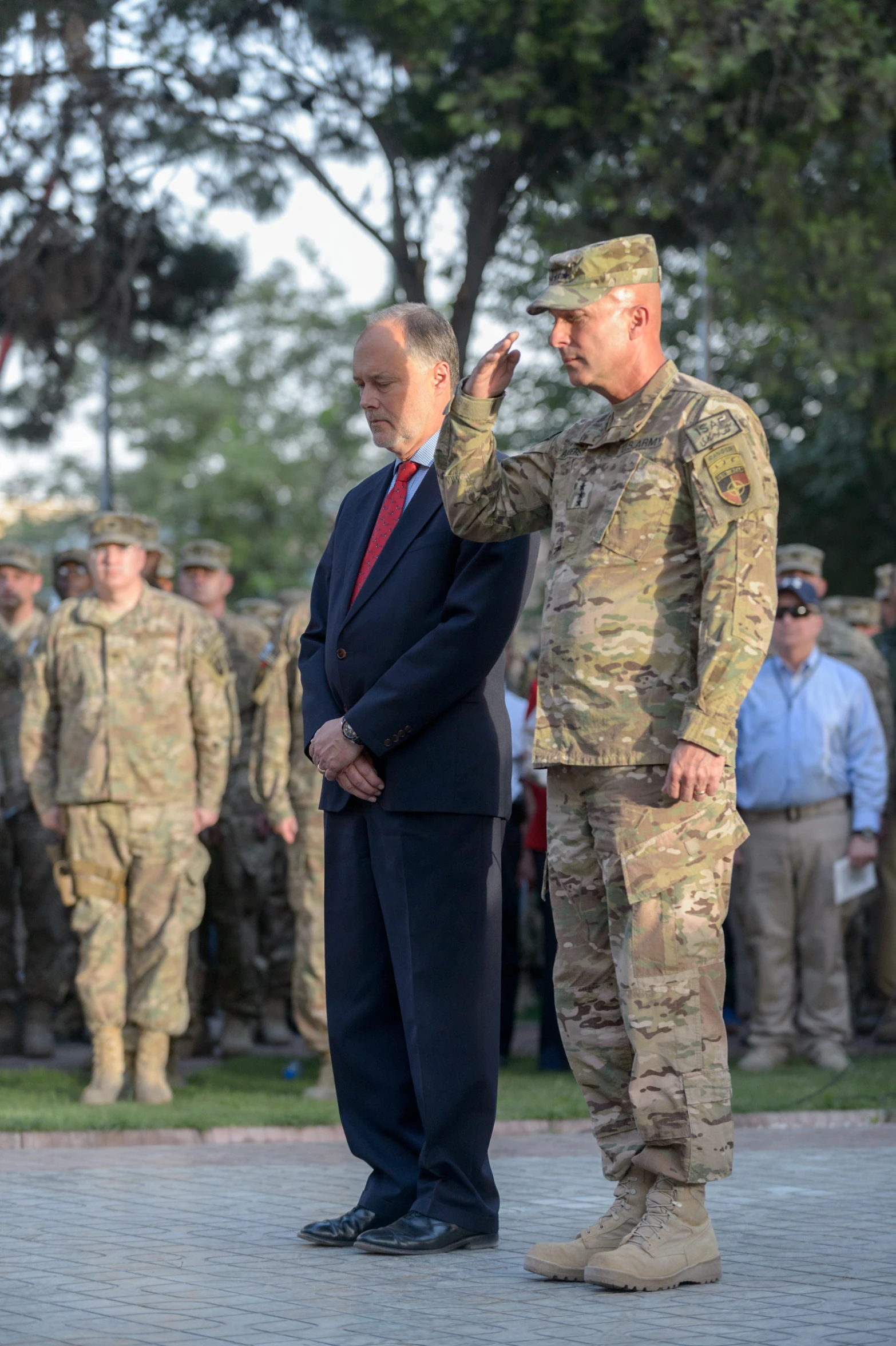 two men in uniform saluting to military officers