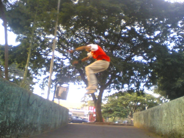 a man doing tricks on a skateboard in a street
