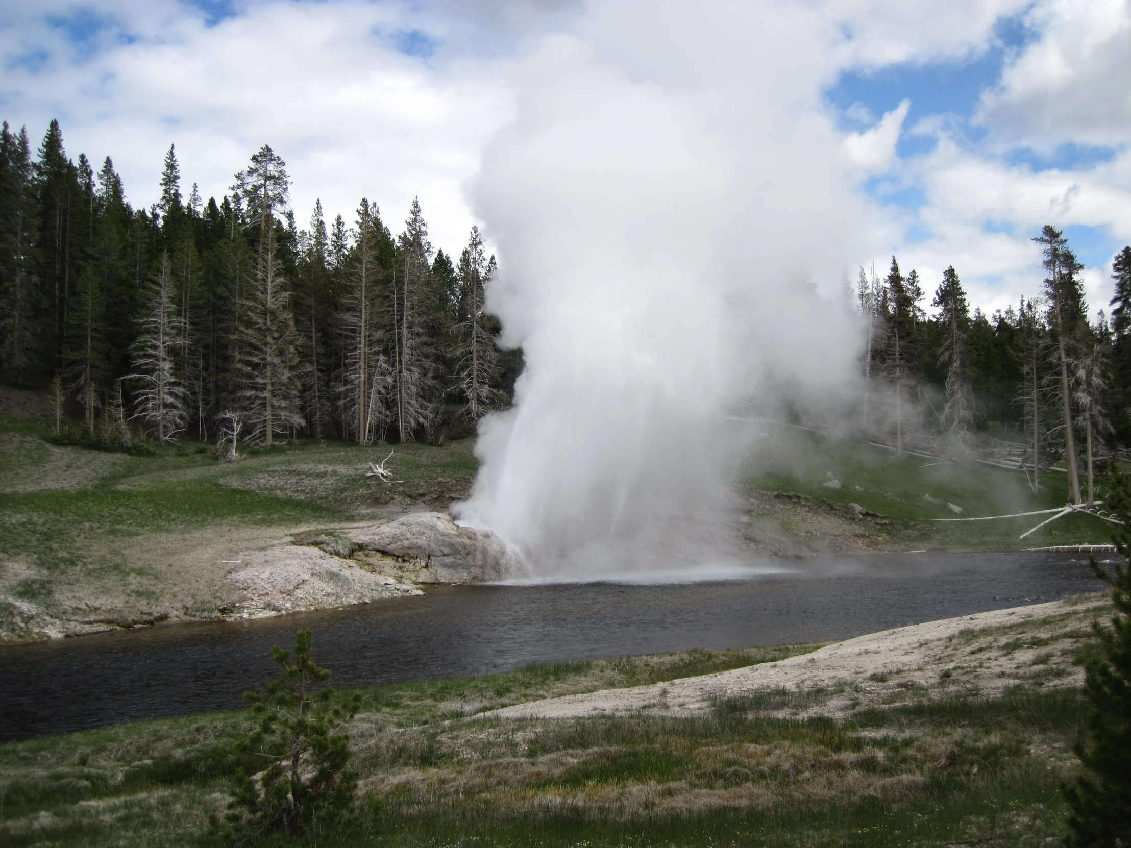 the steam rises as it erupts water into the air