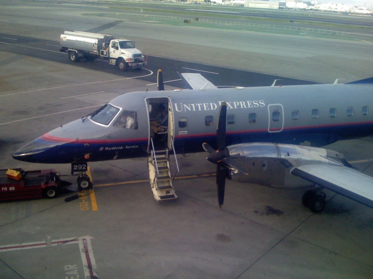 a large blue airplane sitting on top of an airport tarmac