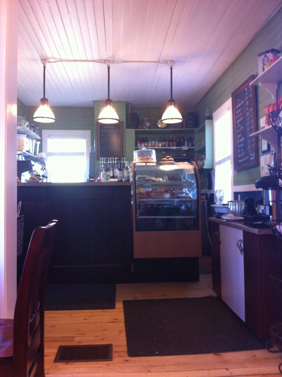 a cafe with two lamps over the counter