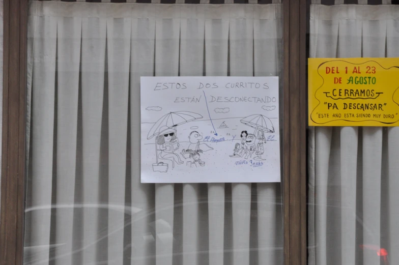an open sign next to a closed window with a drawing on it
