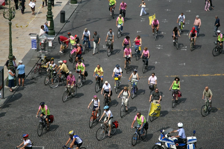 many people riding bikes and bicycles down the street