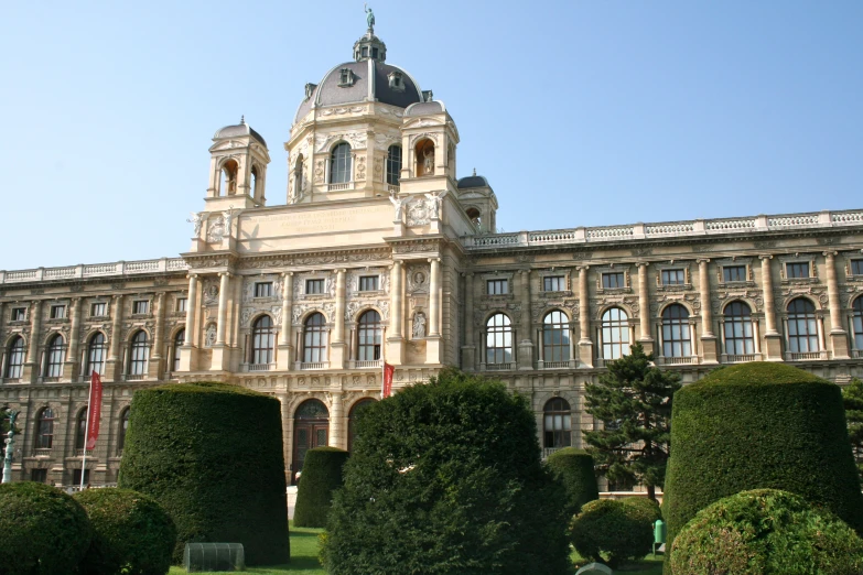 large, majestic building is situated near the green shrubs