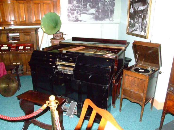 a room filled with an old fashion piano and many other antiques