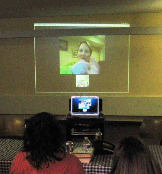 a television screen in a room with a woman watching tv