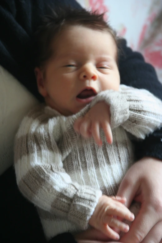 a close up of a person holding a baby