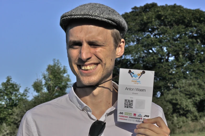 a man wearing a tie holding up a paper with the words prize