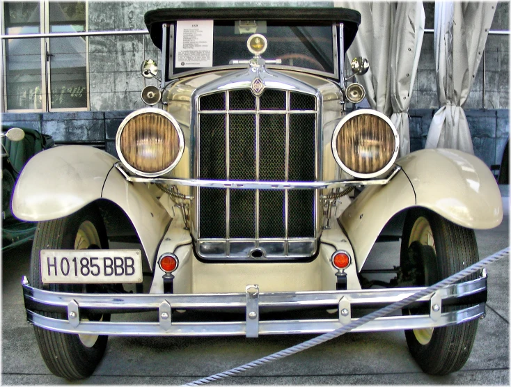 an old - fashioned ford convertible with a shiny front bumper