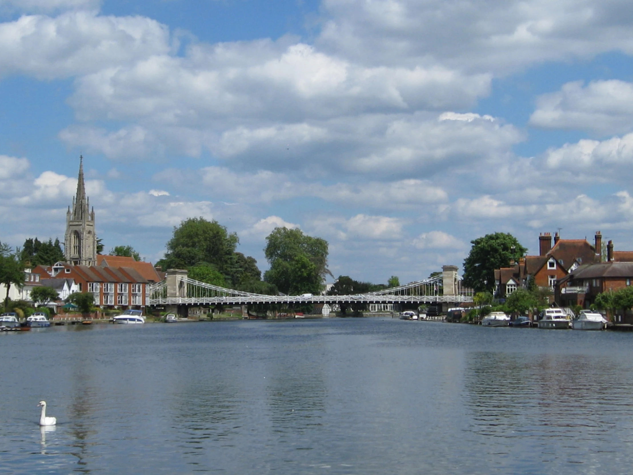 the river has a bridge over it and lots of buildings