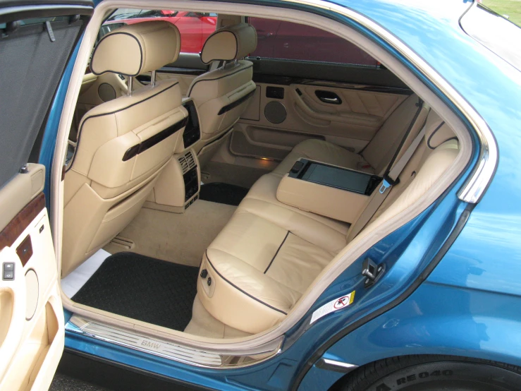 this is the rear door open to a blue sedan