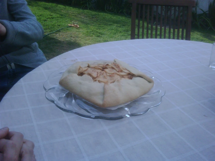 a table with a glass plate topped with a pie