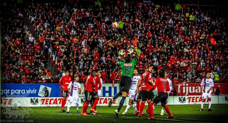 a soccer game is shown during a crowded stadium