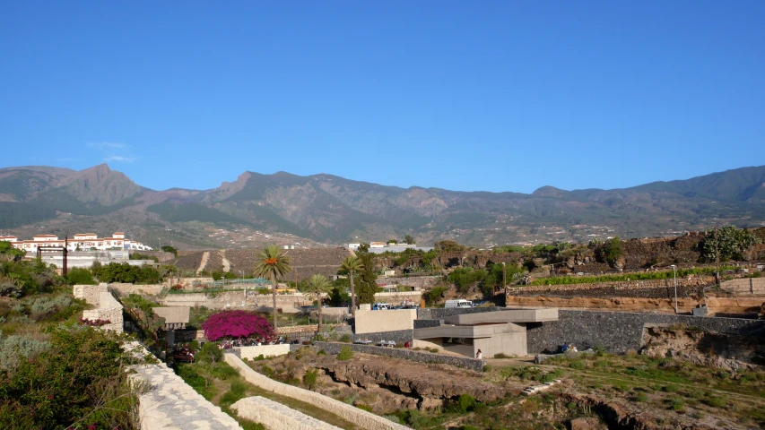 the view of mountains, houses and hills from a hilltop