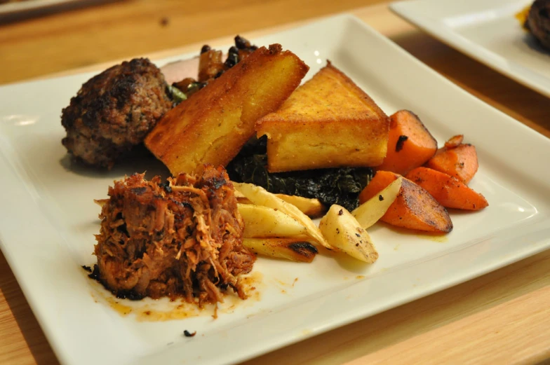 two plates with some food on them sitting on a table