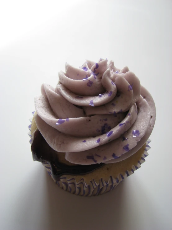 a close up of a chocolate cupcake with frosting