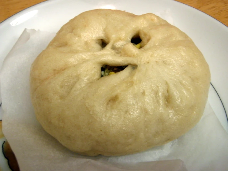 a baked bread donut with some kind of mouth