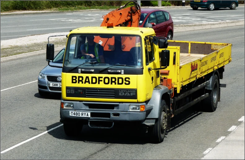 a truck pulling a large wooden object behind it