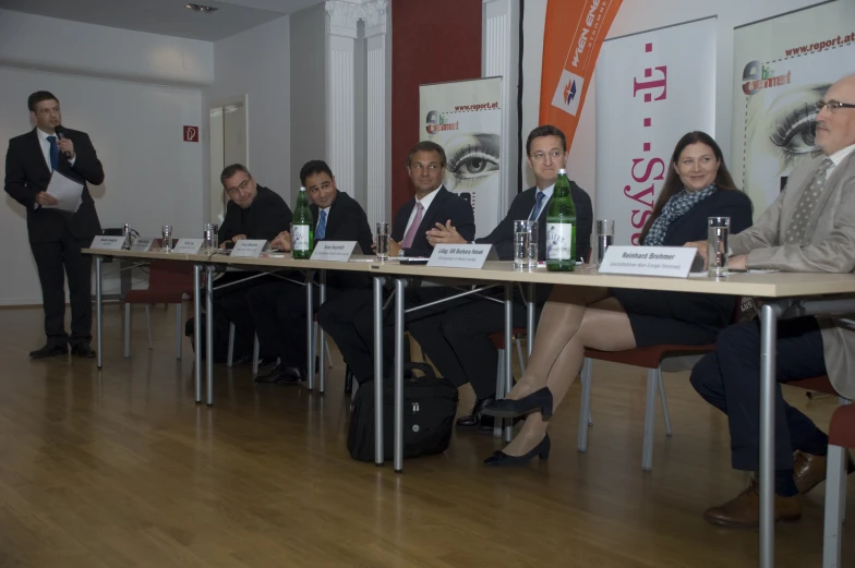 people sitting at tables during a panel discussion