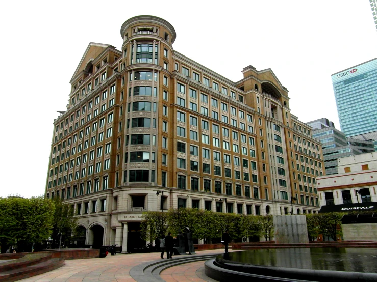 a very big building in front of some trees