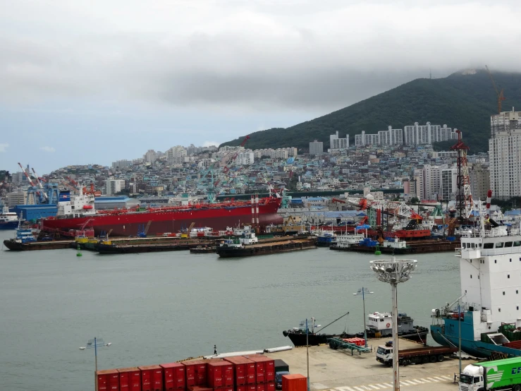 there are many different colored shipping containers in the harbor