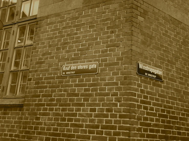 a brick building with street signs written on it