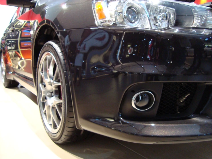 a black sports car on display in a building