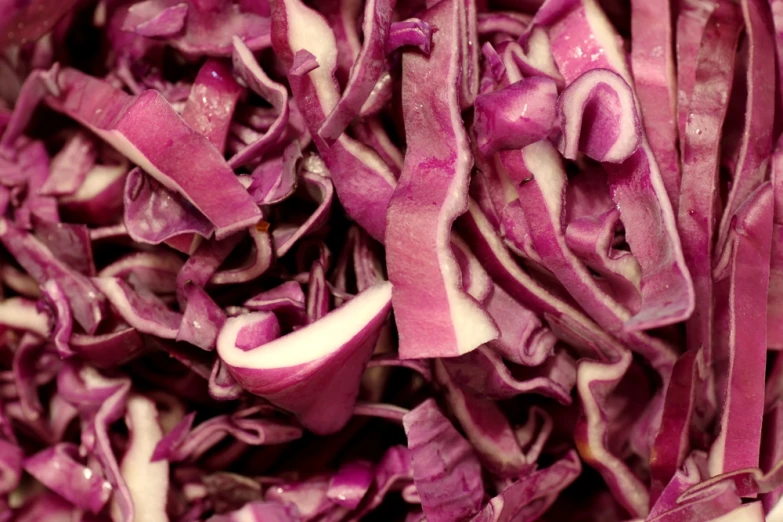 red cabbage that has been sliced and is in a large bowl