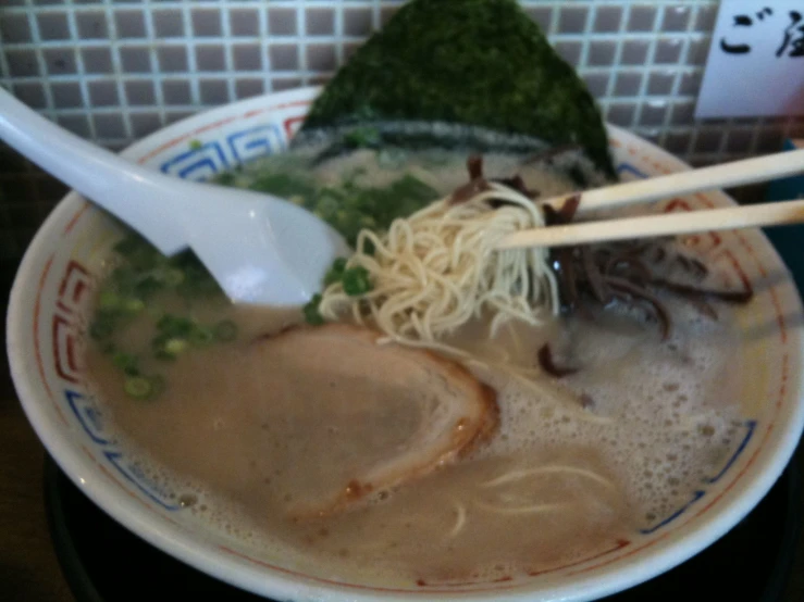 a bowl of soup containing noodles and other foods