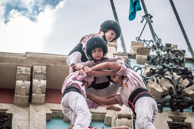 three guys in white outfits playing with ropes