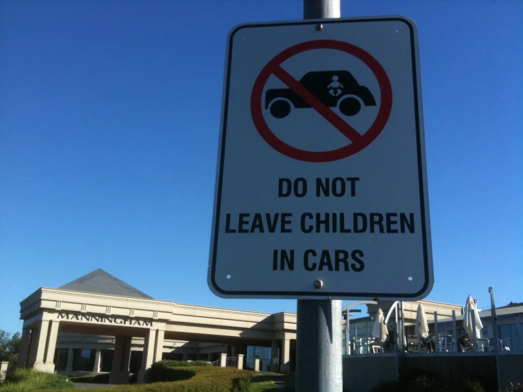 a no children in cars sign on the corner