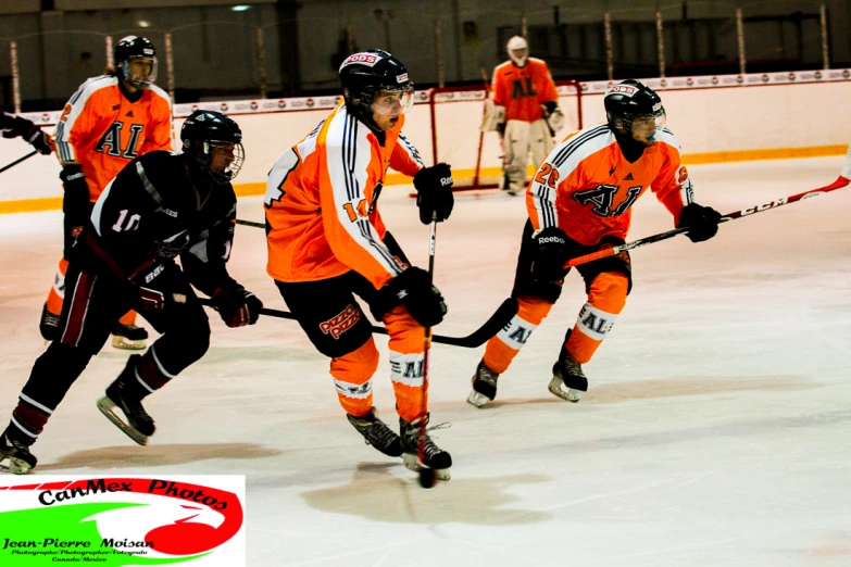 three male ice hockey players running down the ice