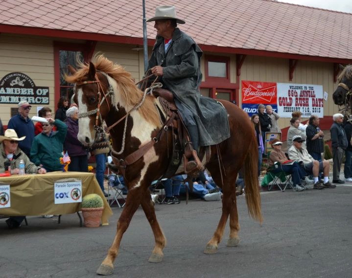 a man is riding on a horse down the street