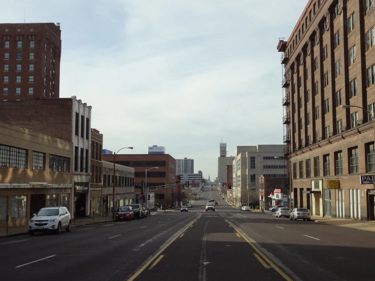 a car parked along side a street with tall buildings