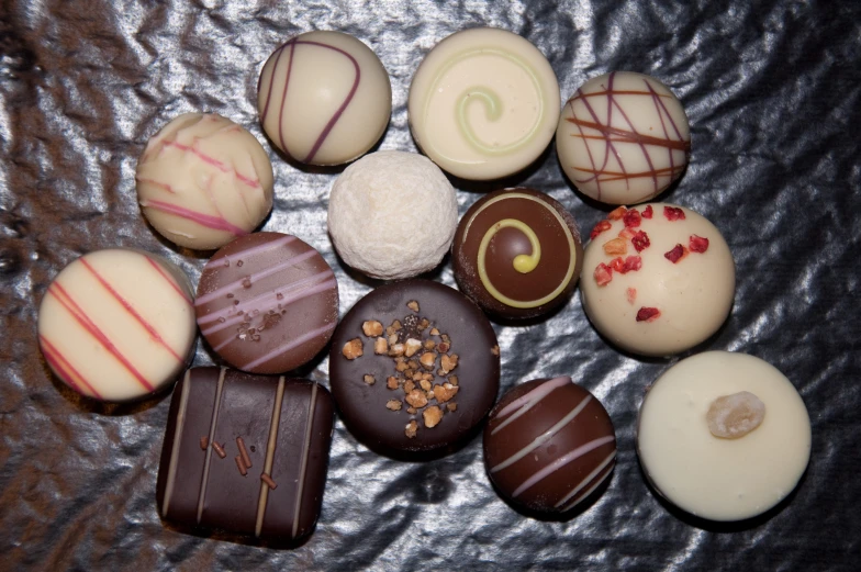 a large amount of different colored chocolates arranged on a table