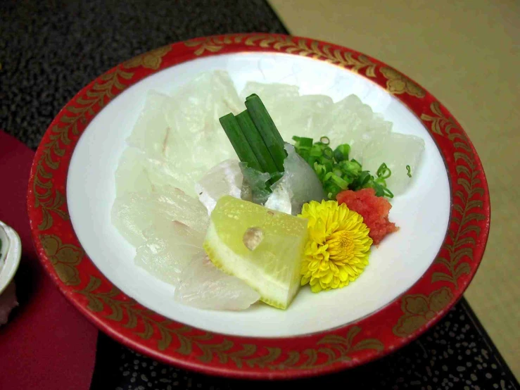 a bowl filled with assorted flowers on top of a counter