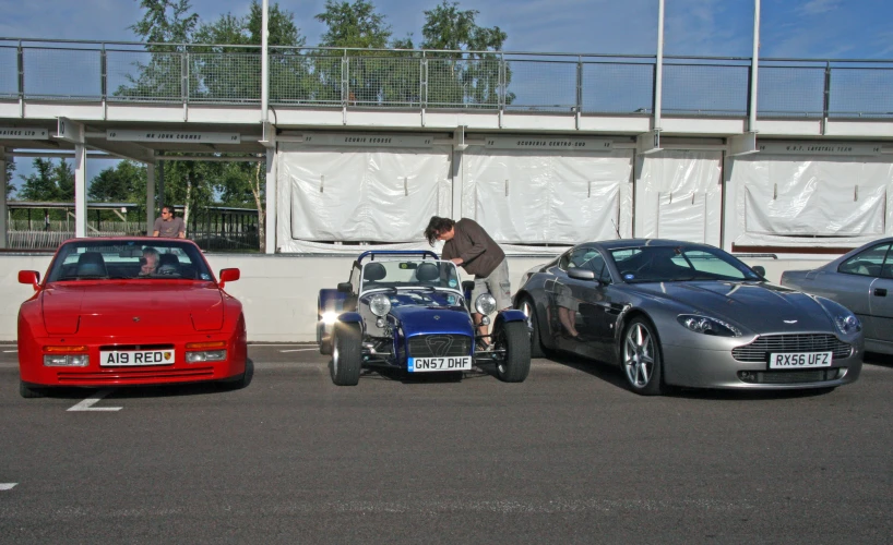 a man is standing by cars with one side of the car