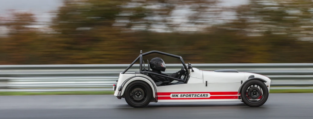 an old race car driving down a track