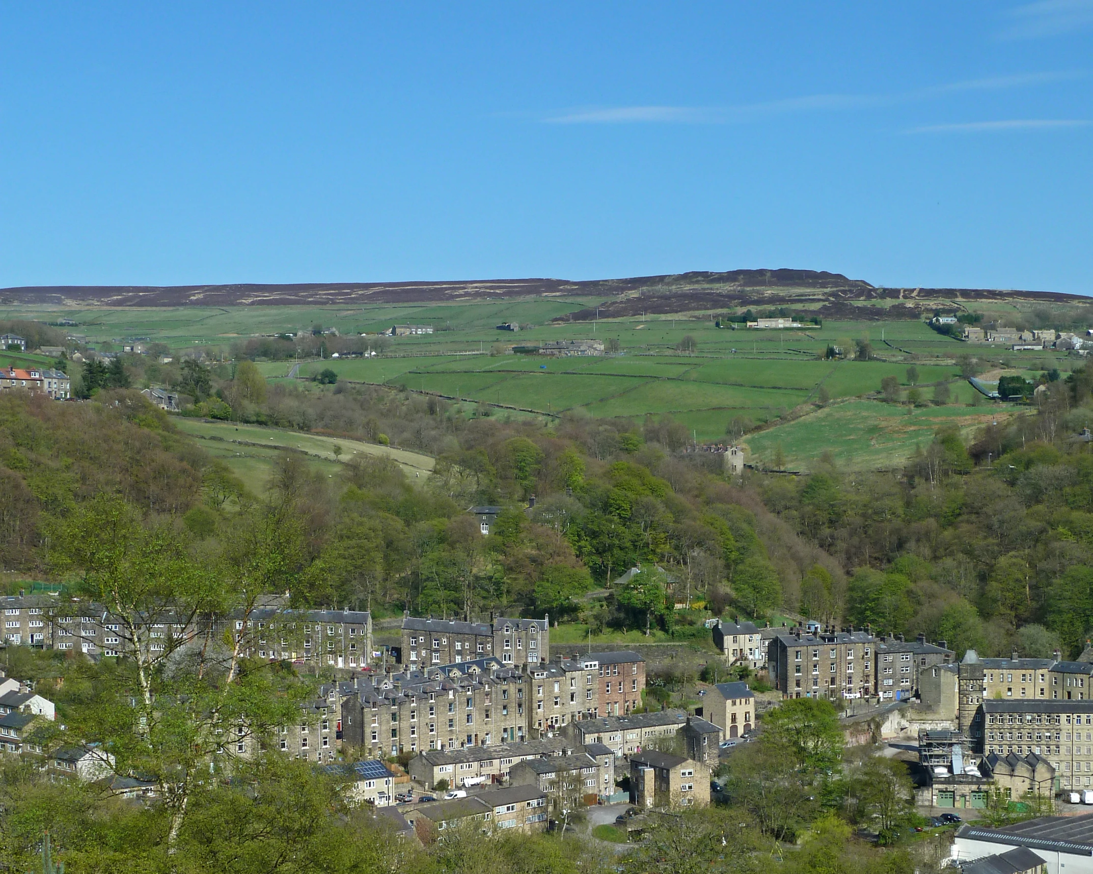 the countryside is full of green hills and trees