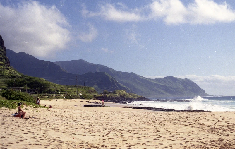 a view of a beach with waves and people