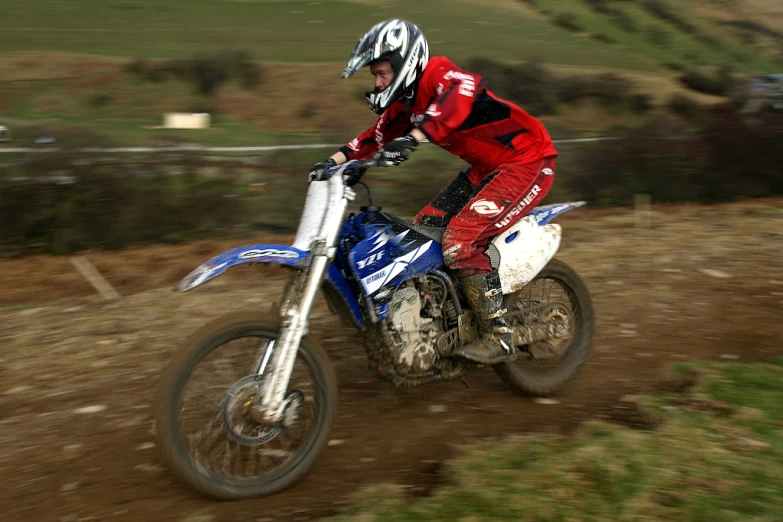 a man riding a dirt bike on a trail