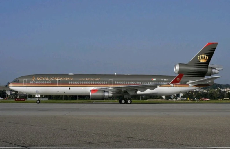 a red and white commercial airliner on a runway