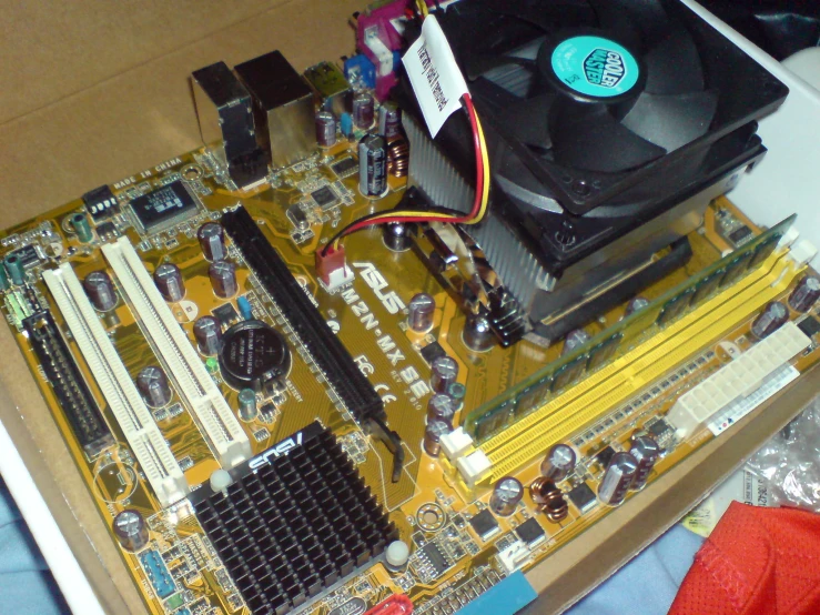 an open computer board with its wires and components being worked on