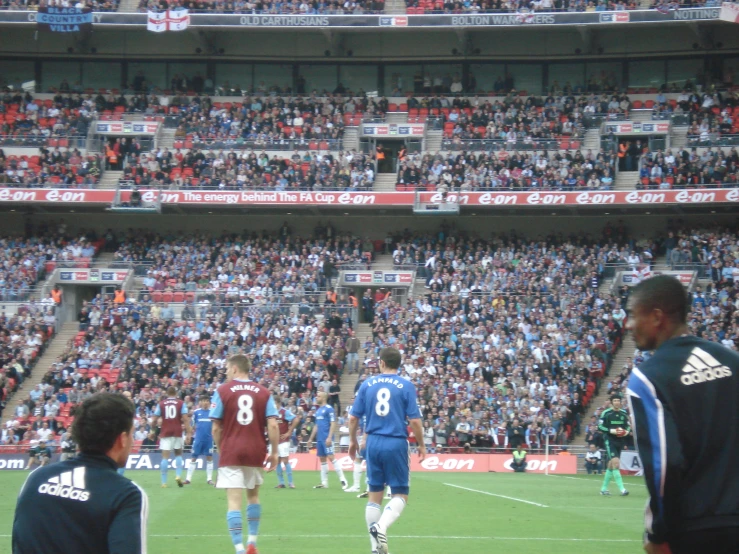 a soccer team plays in a stadium for a full crowd