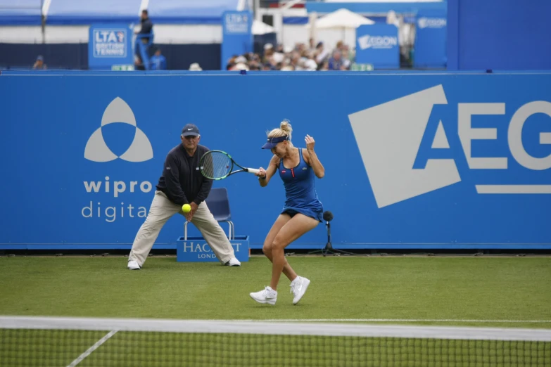 two women playing tennis in the middle of an umpire's hand