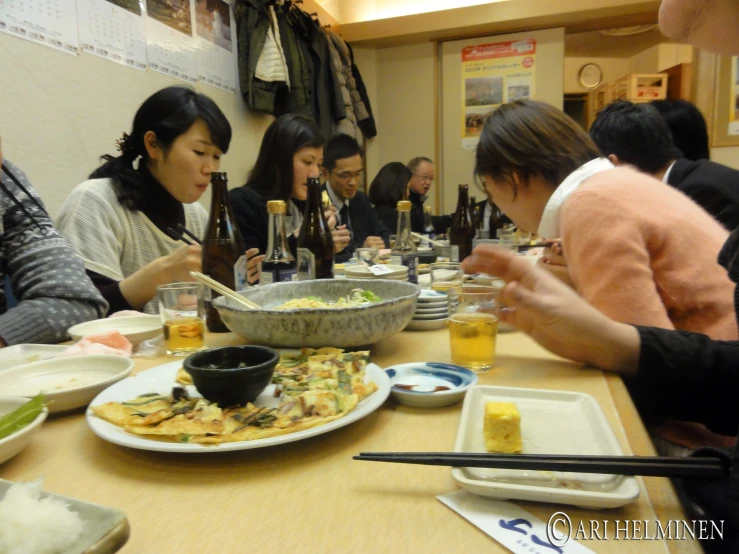 a group of people gathered at a table eating food