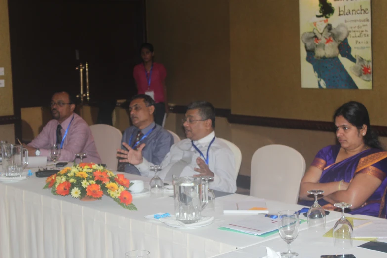 several people sitting around a table at a business conference