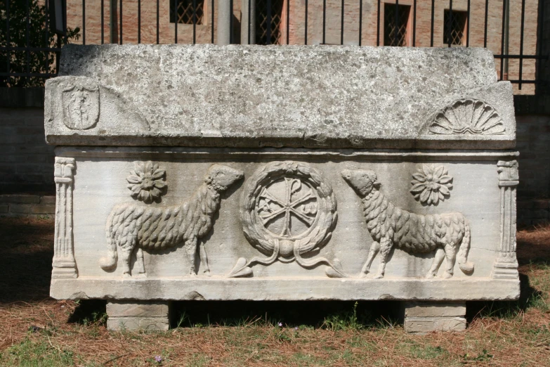 an ancient carving with sheeps around the wheel of time