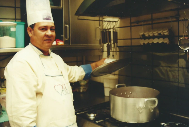 a man wearing a chef's hat while preparing food